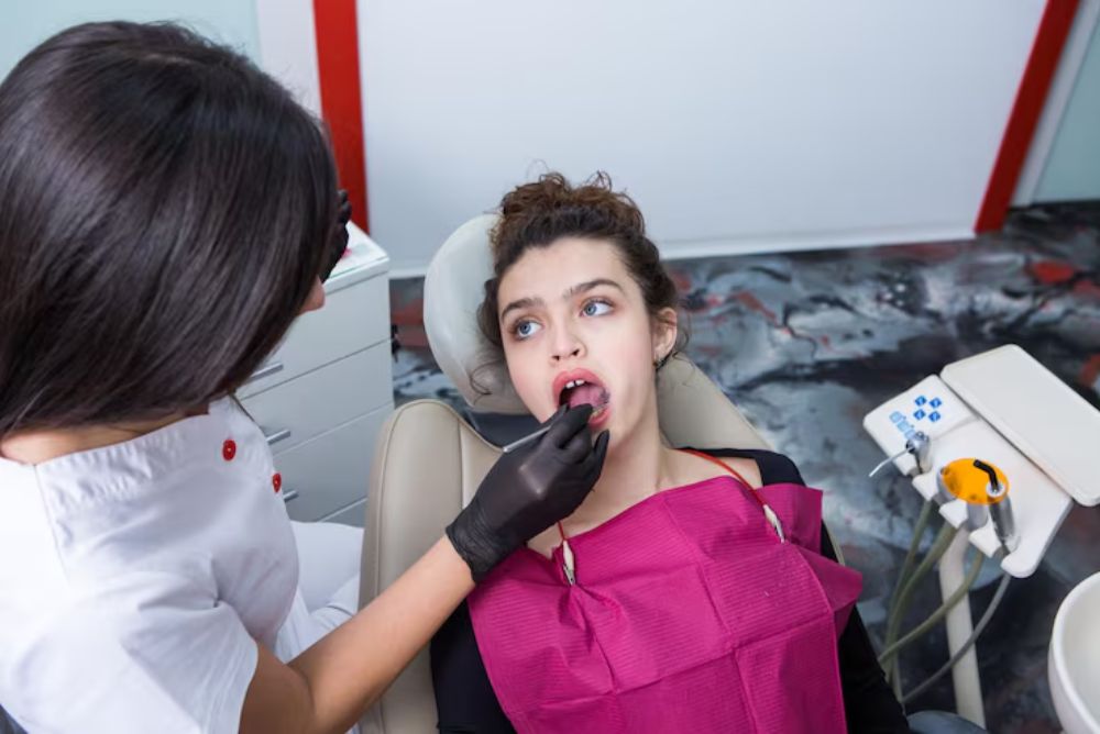 dentist performing a root canal procedure to treat an infected tooth